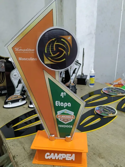 Troféu de voleibol em laranja e preto. Fotografia de trabalho da VLT Acrílicos.